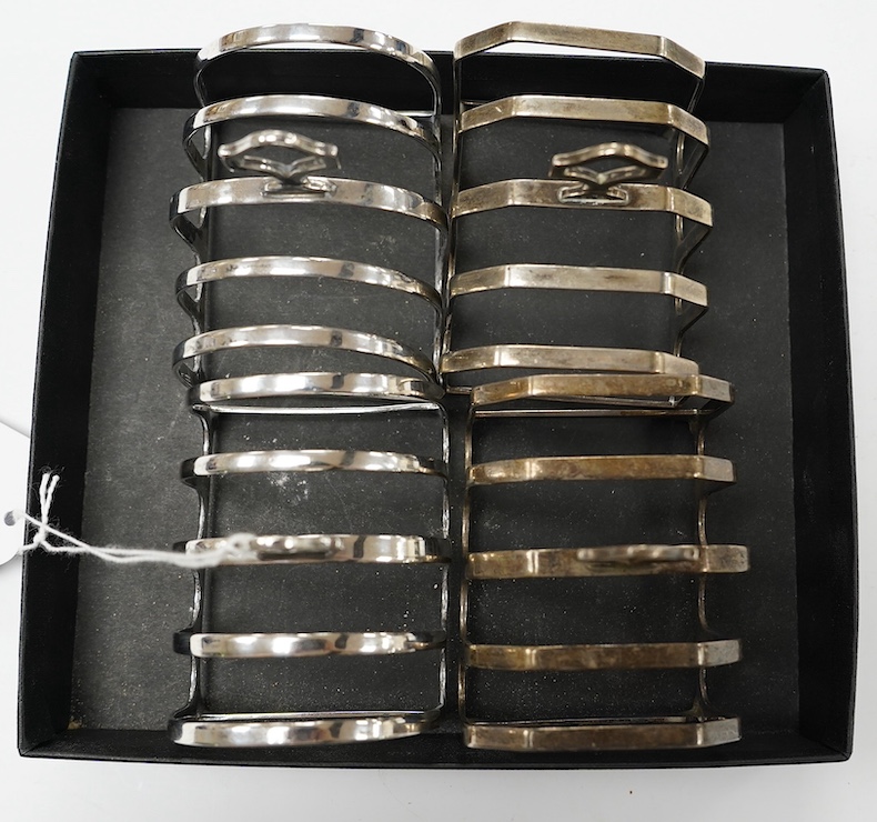 Two pairs of silver five bar toast racks, Birmingham, 1931 and Birmingham, 1932, 75mm, 10.7oz. Condition - fair